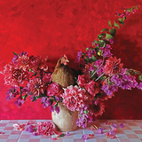 Chicken sitting among pink and purple flowers on a checkered tablecloth with a red background